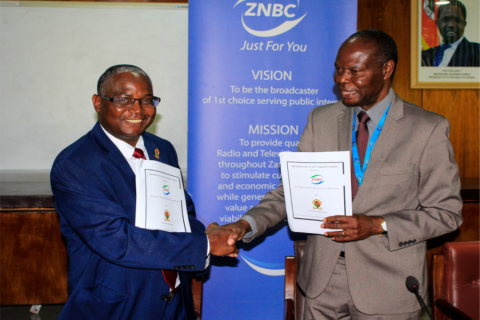 UNZA Vice-Chancellor, Prof. Luke Mumba (left), shakes hands with ZNBC Director General, Mr. Richard Mwanza (right), after signing the Memorandum of Understanding in the Senate Chamber.
