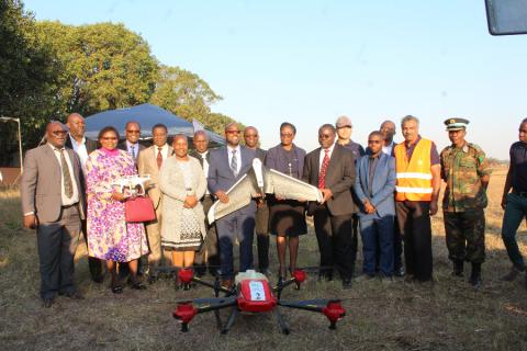 Minister poses for a photo after the demonstration of the Flying Lab at the Goma fields