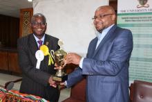 UNZA Vice-Chancellor, Prof. Luke Mumba receives trophies from Acting Deputy Vice-Chancellor, Dr. Jolly Kamwanga during the Trophy Handover ceremony held yesterday, 3 September 2018 in the Senate Chamber